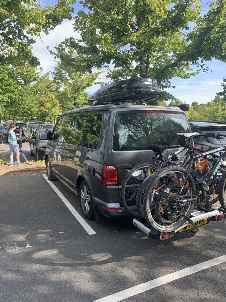 Campervan parked in Paris with bike rack and roof box