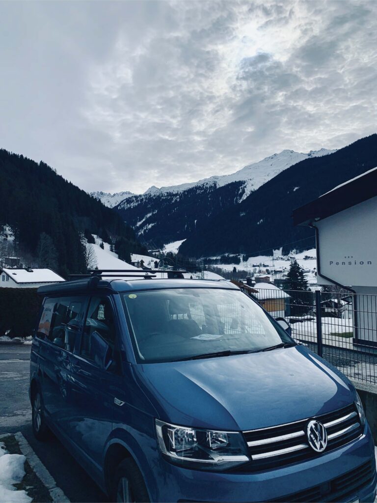 winter-holiday-in-a-campervan-parked-in-a-ski-resort
